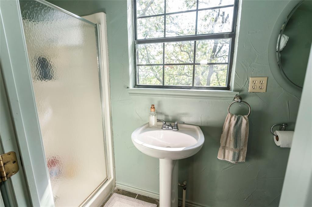 698 Storey Road Nocona, TX 76255 - Photo 29 of 34 a bathroom with a sink a mirror and a window