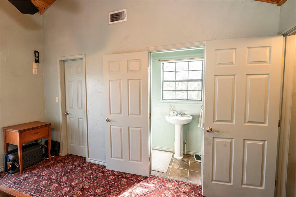 698 Storey Road Nocona, TX 76255 - Photo 31 of 34 a bedroom with a bed and a table in it