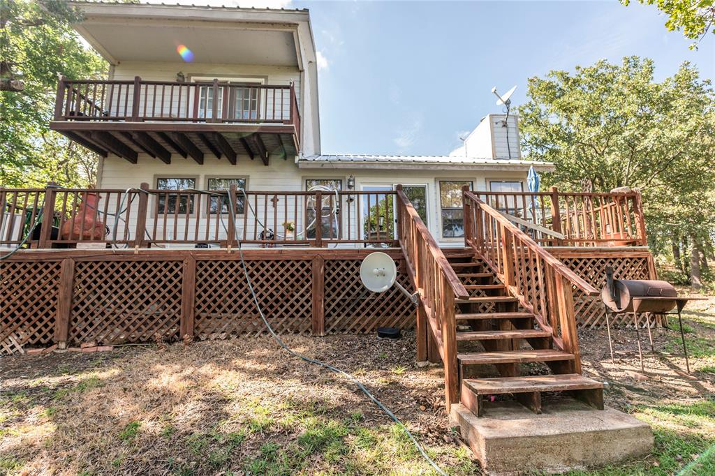698 Storey Road Nocona, TX 76255 - Photo 6 of 34 a view of a wooden house with a deck