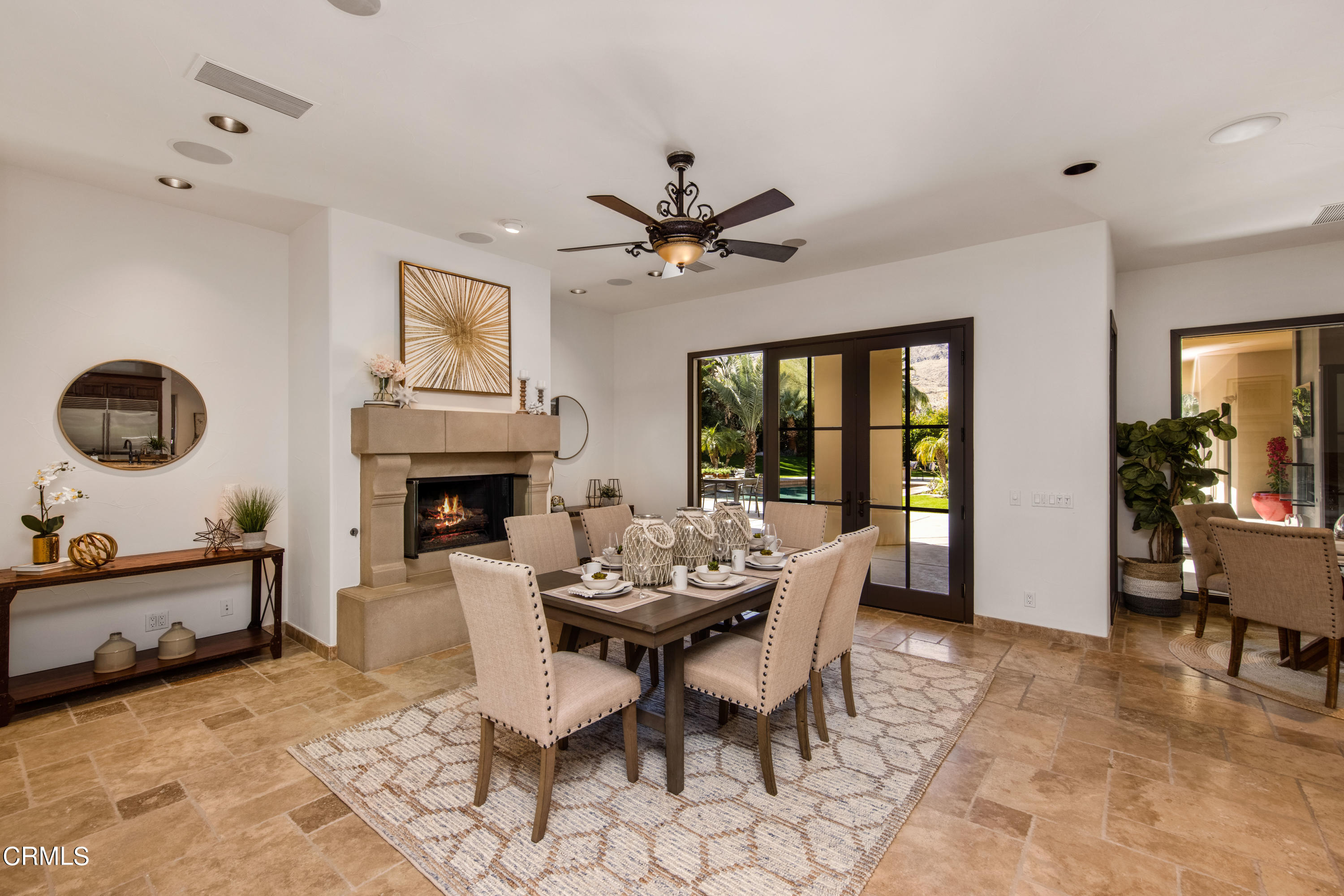 64435 Via Risso Palm Springs, CA 92264 - Photo 21 of 65 a dining room with furniture a fireplace and a chandelier