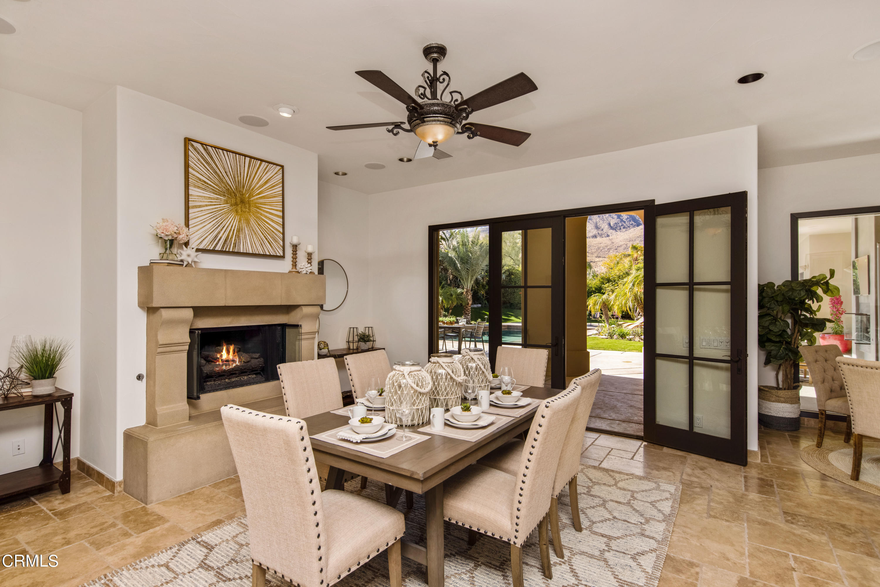 64435 Via Risso Palm Springs, CA 92264 - Photo 22 of 65 a living room with furniture a fireplace and a floor to ceiling window