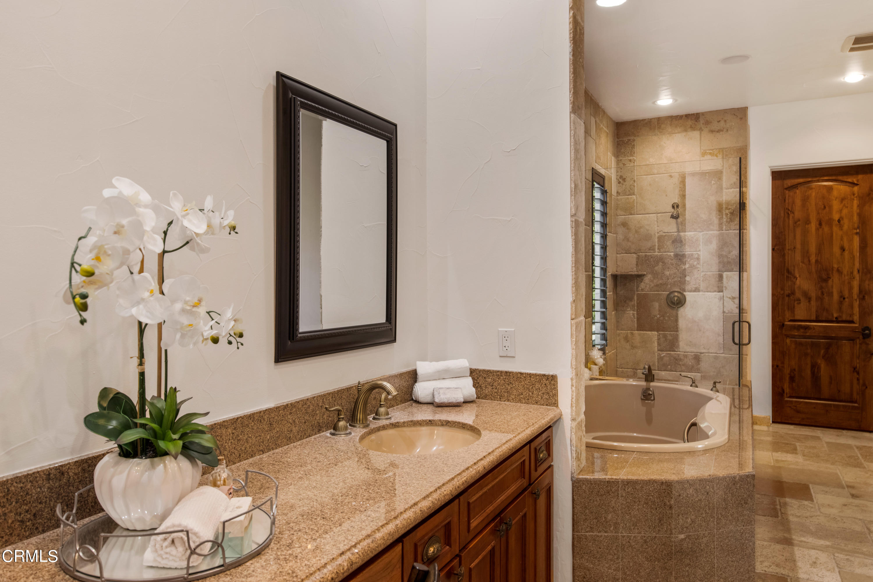 64435 Via Risso Palm Springs, CA 92264 - Photo 32 of 65 a bathroom with a granite countertop sink a mirror and a shower