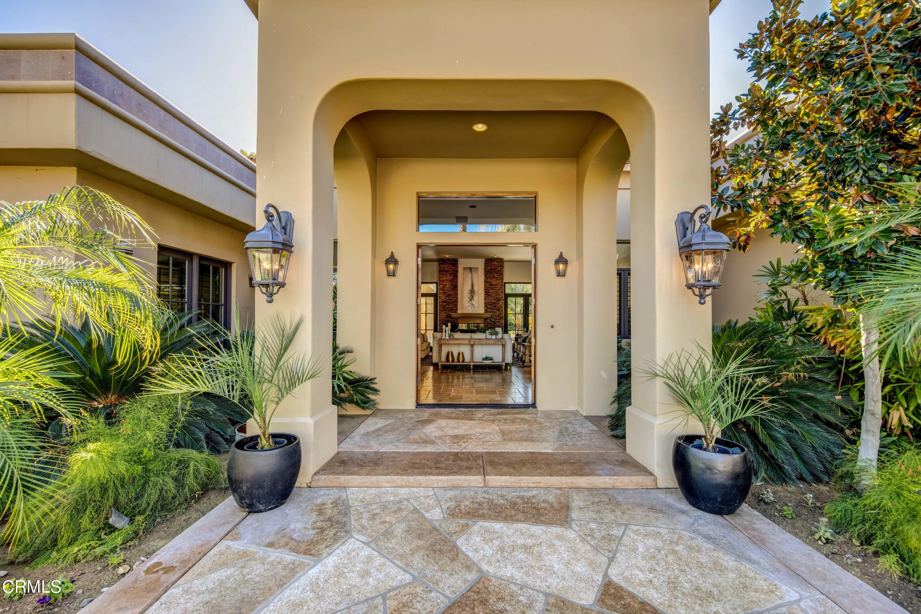 64435 Via Risso Palm Springs, CA 92264 - Photo 6 of 65 a view of a entryway door of the house with potted plants