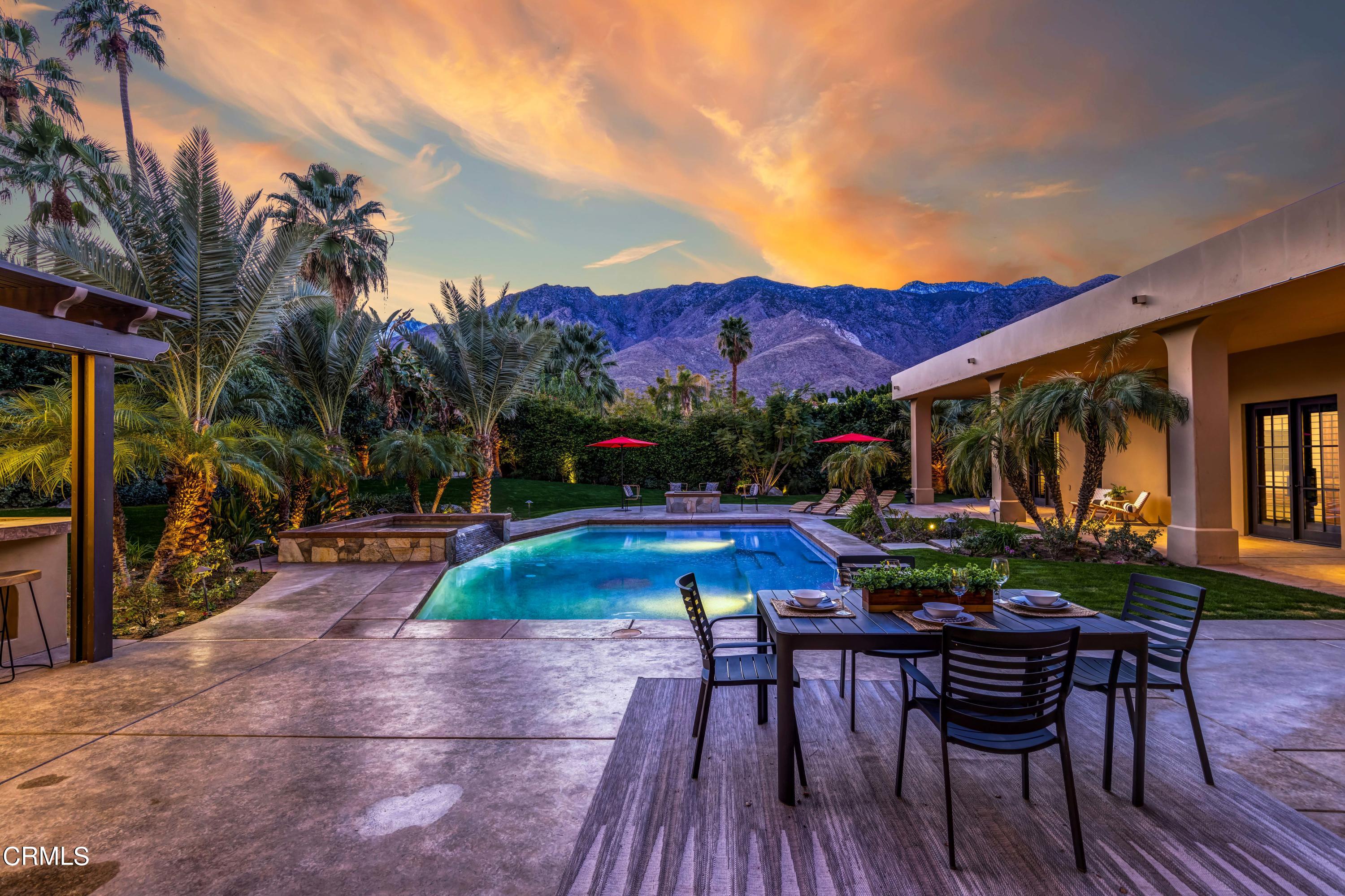 64435 Via Risso Palm Springs, CA 92264 - Photo 62 of 65 a view of patio with table and chairs potted plants and palm tree