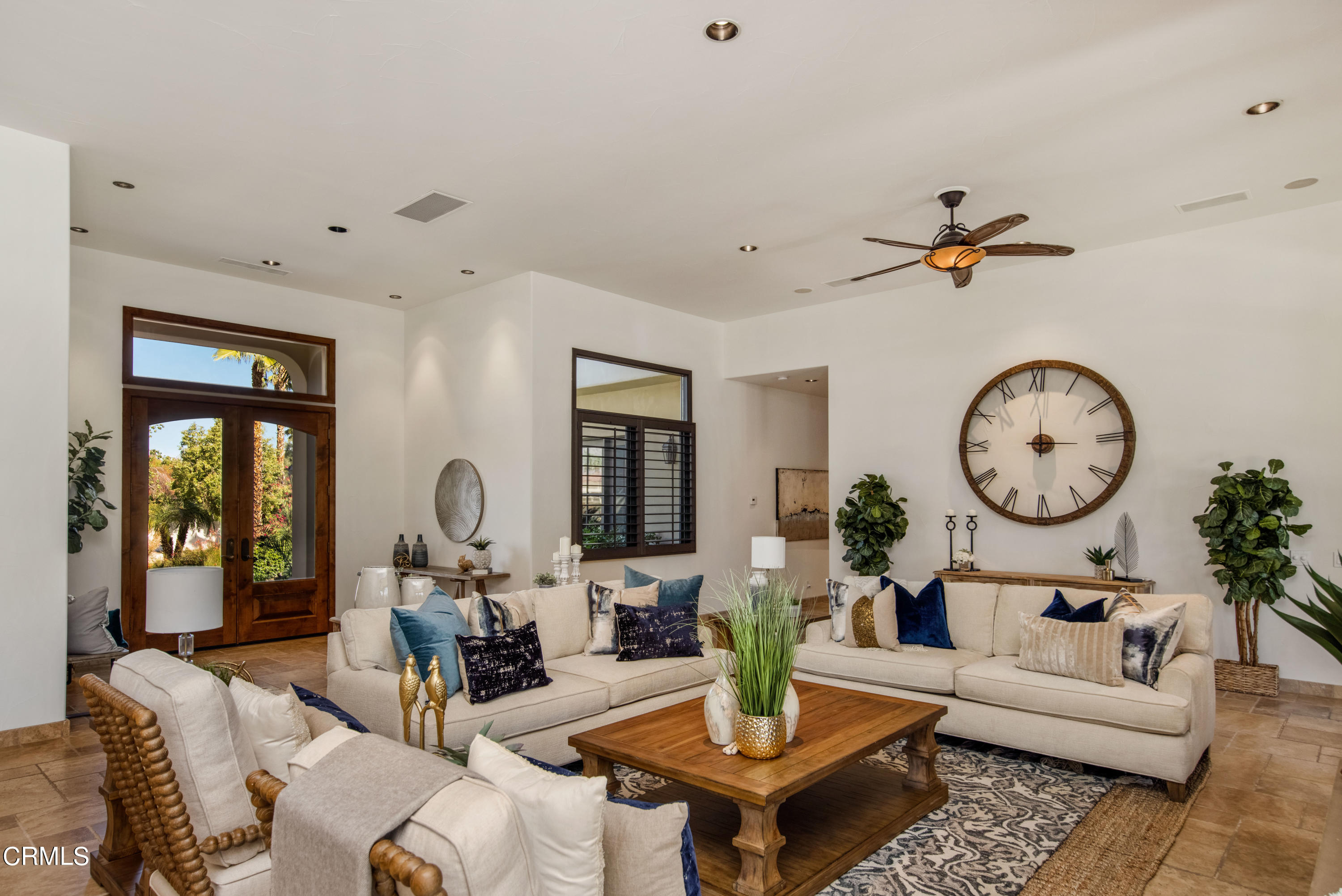 64435 Via Risso Palm Springs, CA 92264 - Photo 8 of 65 a living room with furniture a clock and a large mirror