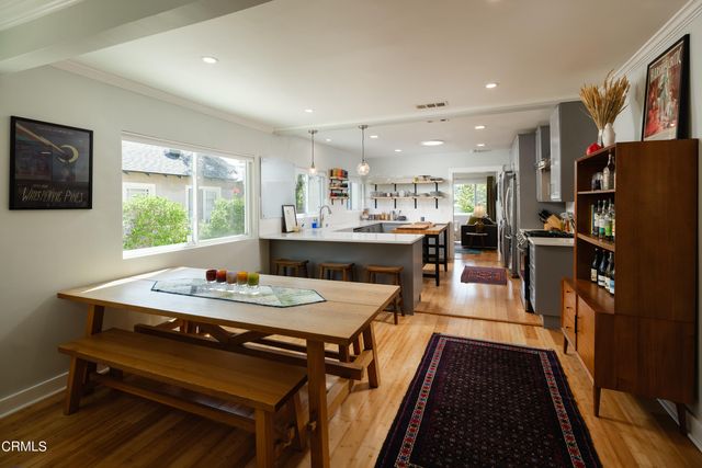 a kitchen with kitchen island a refrigerator stove and sink
