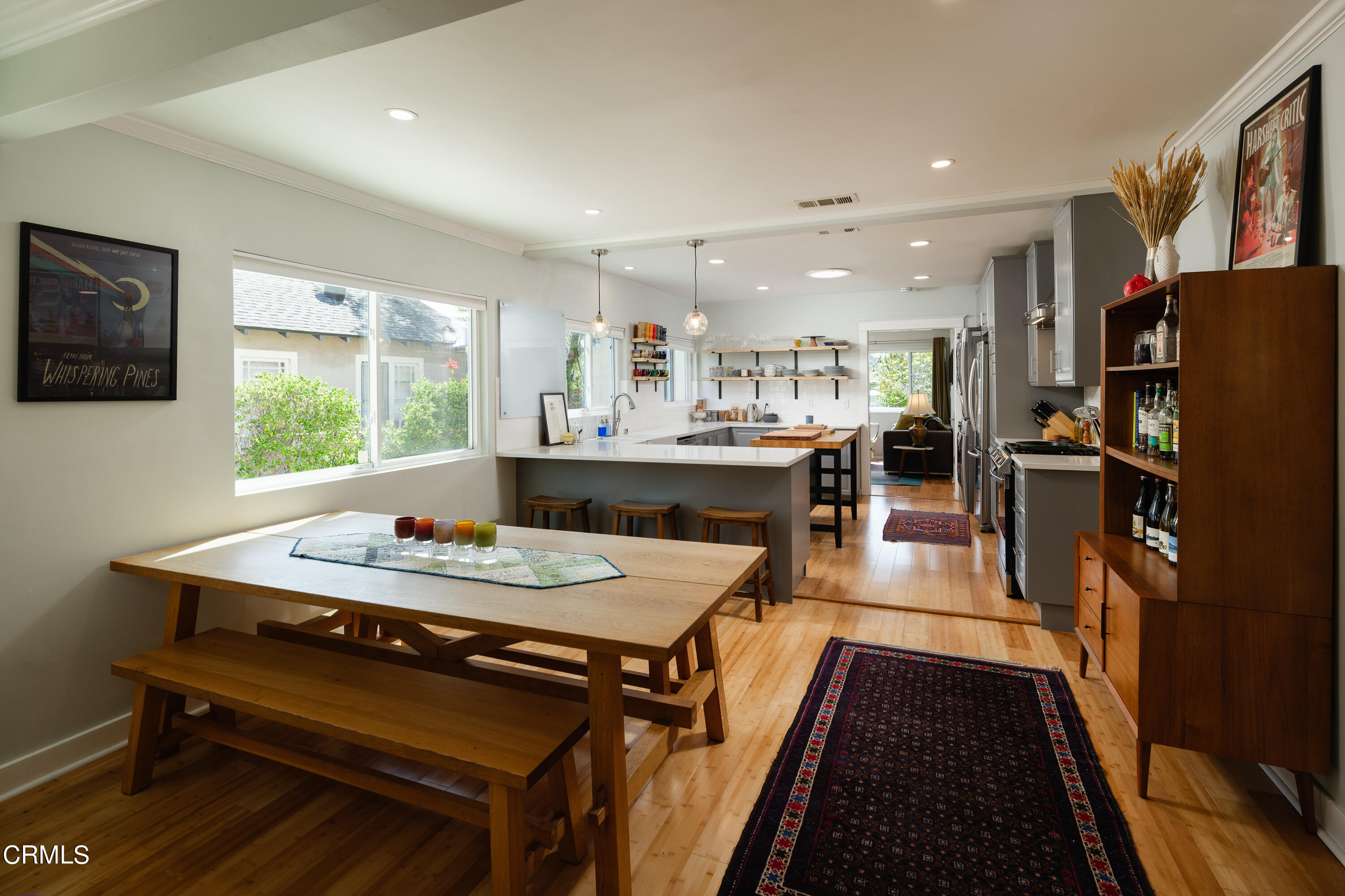 1794 Beverly Drive Pasadena, CA 91104 - Photo 12 of 56 a dining hall with stainless steel appliances granite countertop a table chairs and a refrigerator