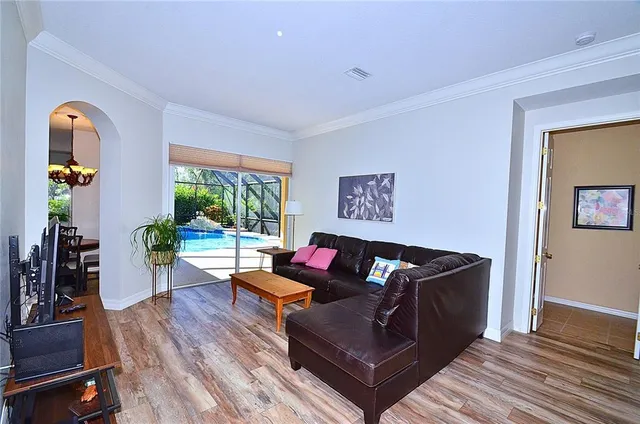 a living room with furniture and wooden floor