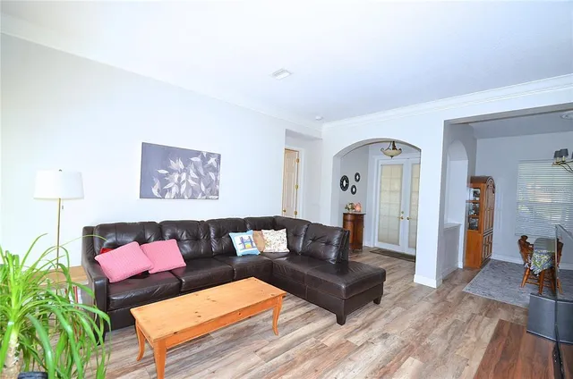 a living room with furniture and wooden floor