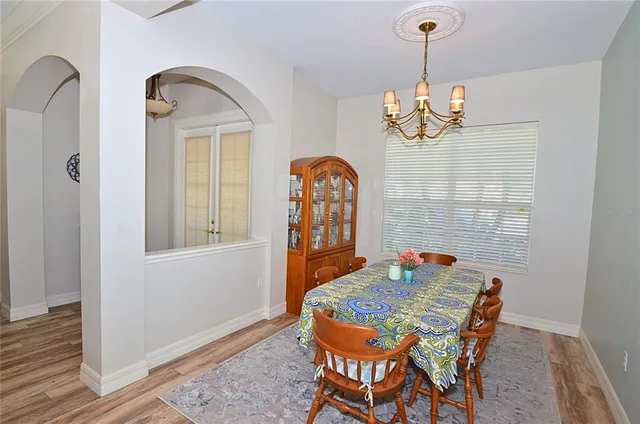a view of a dining room with furniture wooden floor and chandelier