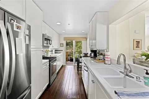 a kitchen with a stove a sink and a microwave