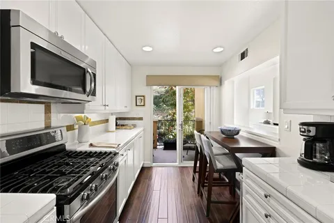 a kitchen with stainless steel appliances a stove sink microwave and cabinets