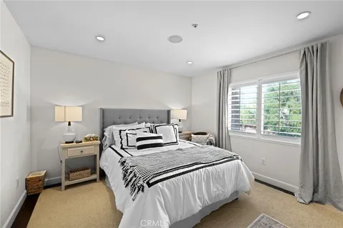 a bedroom with a bed and a lamp