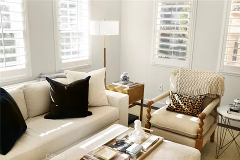 a living room with furniture a couch and a window