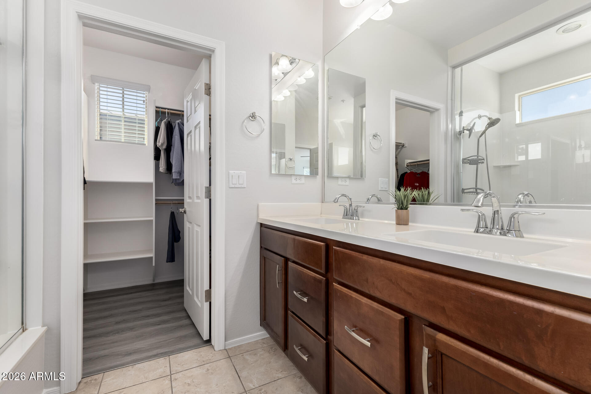 3469 East Indigo Street Gilbert, AZ 85298 - Photo 16 of 32 a bathroom with a double vanity sink a mirror and a shower