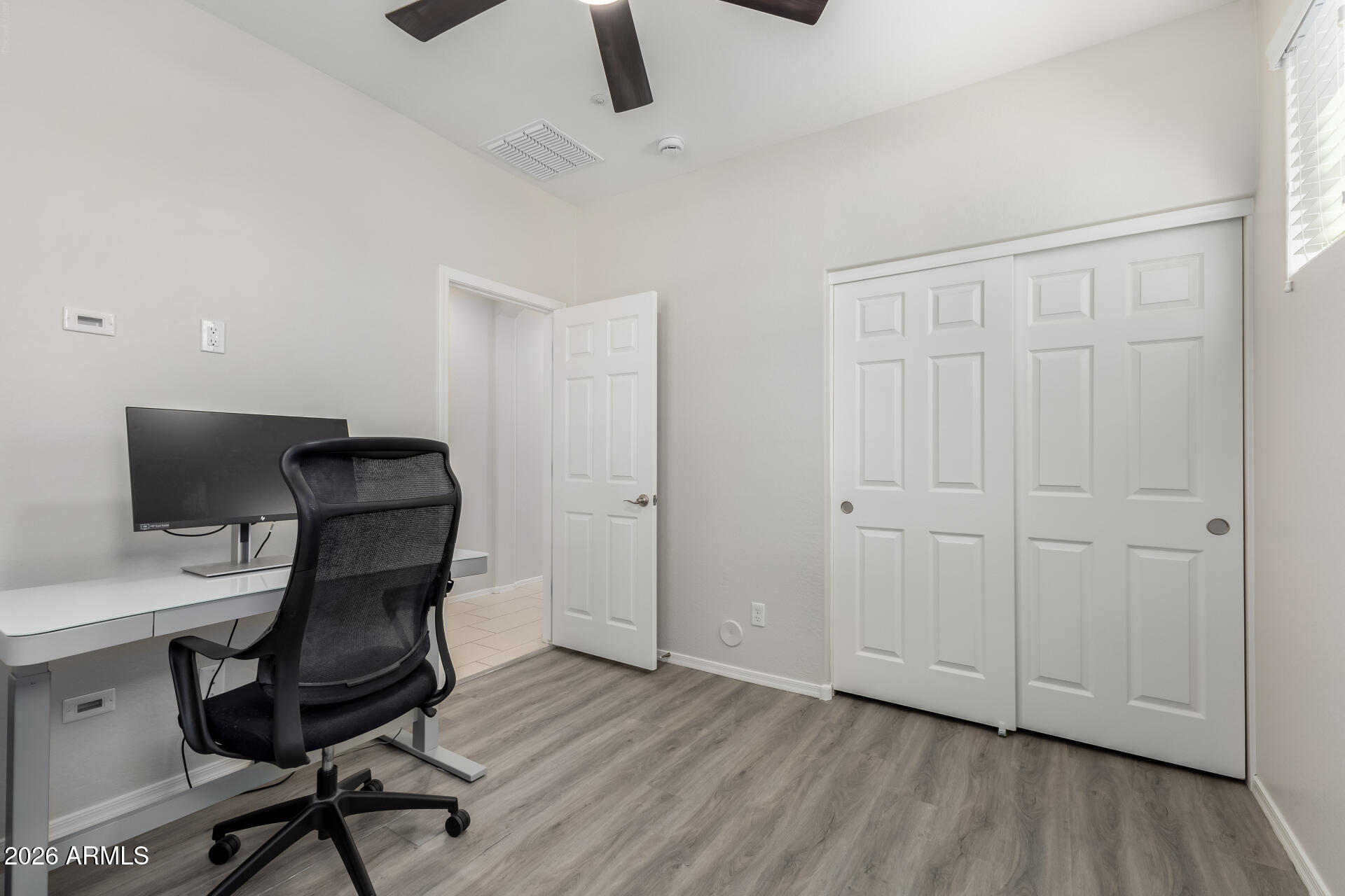 3469 East Indigo Street Gilbert, AZ 85298 - Photo 20 of 32 a view of a workspace with furniture and wooden floor