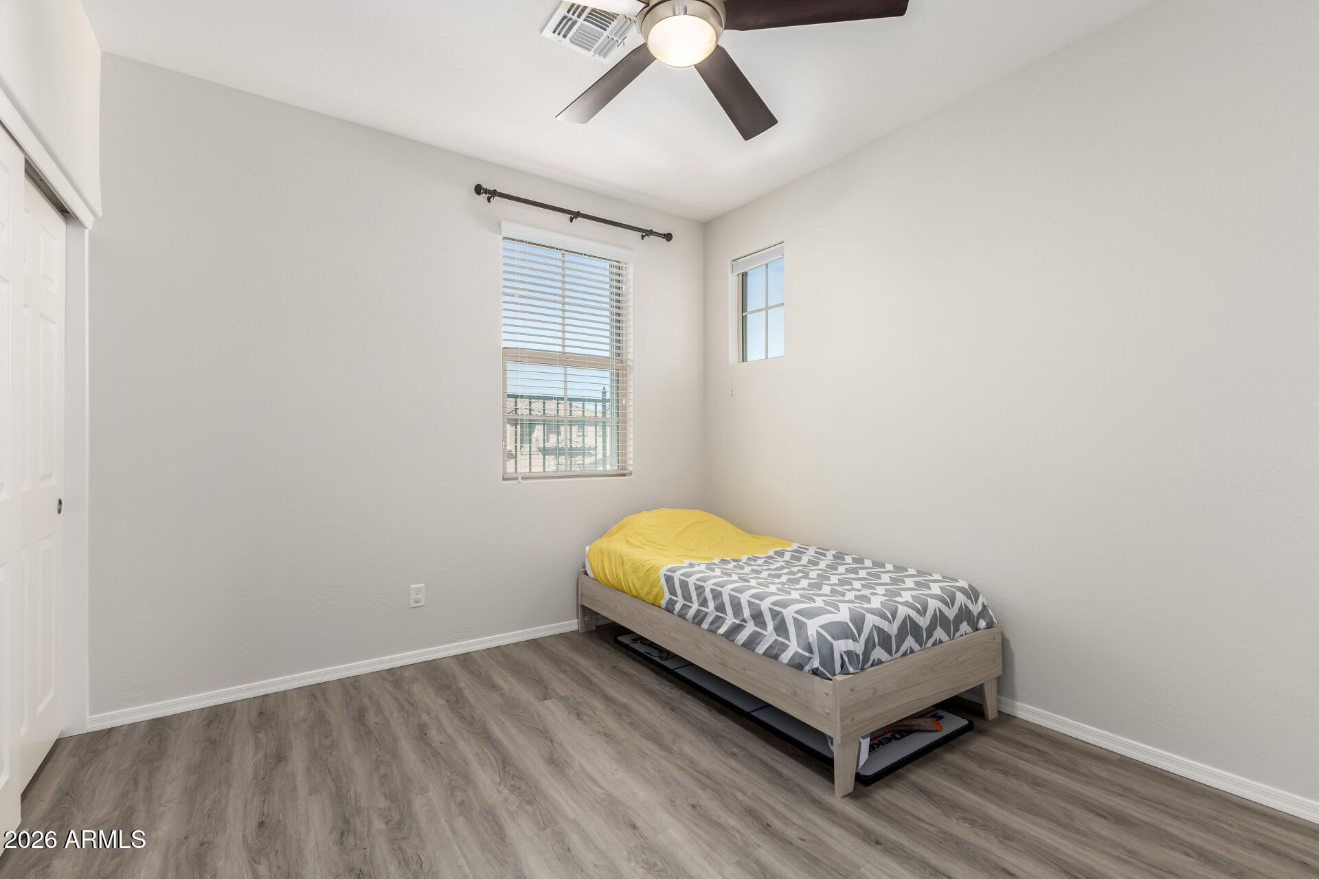 3469 East Indigo Street Gilbert, AZ 85298 - Photo 21 of 32 a room with a bed window and wooden floor