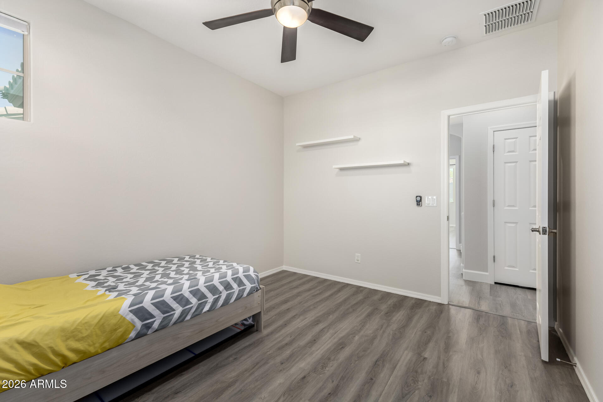 3469 East Indigo Street Gilbert, AZ 85298 - Photo 22 of 32 wooden floor in a bedroom next to a bedroom