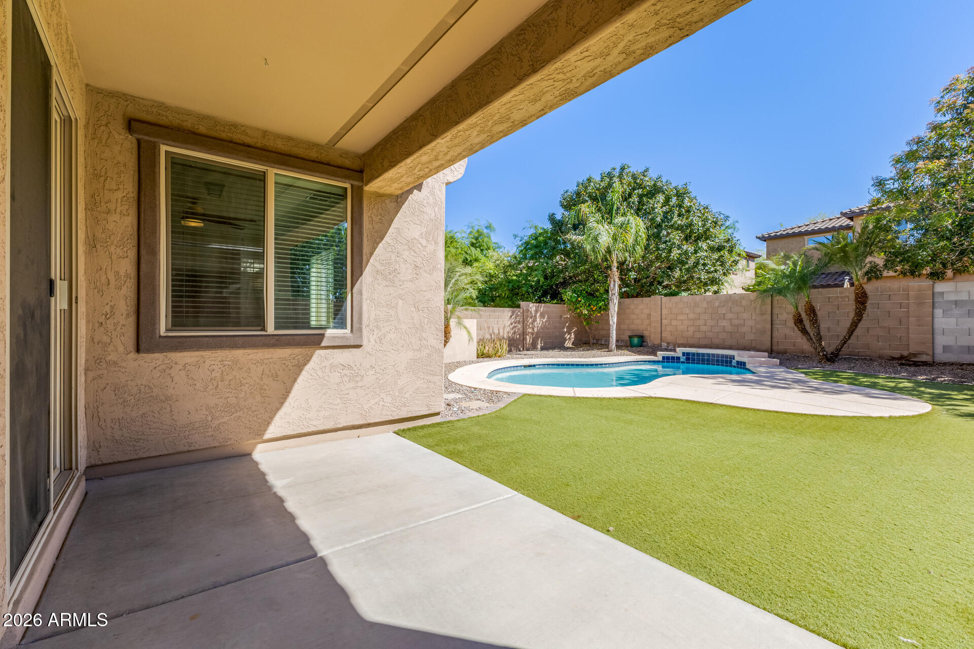 3469 East Indigo Street Gilbert, AZ 85298 - Photo 28 of 32 a view of a swimming pool with a yard