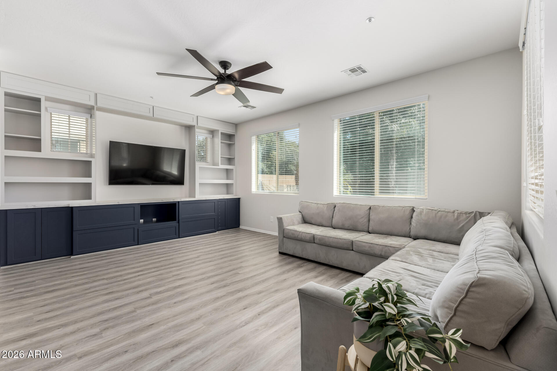 3469 East Indigo Street Gilbert, AZ 85298 - Photo 4 of 32 a living room with furniture and a flat screen tv