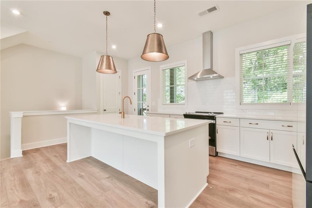 235 Firefly Circle Alpharetta, GA 30009 - Photo 12 of 30 a kitchen with white cabinets and window