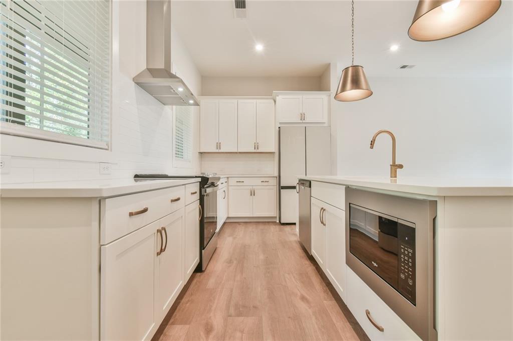 235 Firefly Circle Alpharetta, GA 30009 - Photo 14 of 30 a kitchen with cabinets a sink and a stove