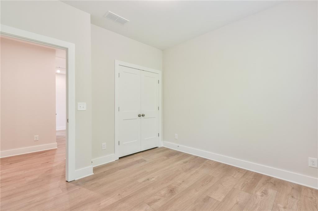 235 Firefly Circle Alpharetta, GA 30009 - Photo 16 of 30 an empty room with wooden floor