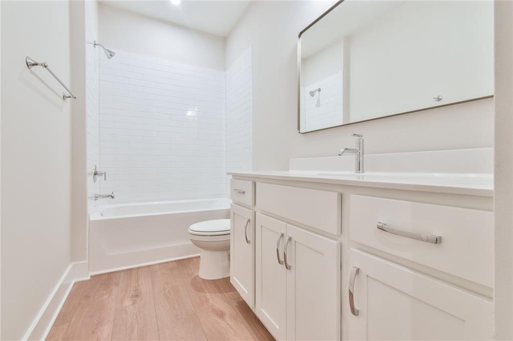 235 Firefly Circle Alpharetta, GA 30009 - Photo 17 of 30 a bathroom with a toilet a sink a vanity and bathtub