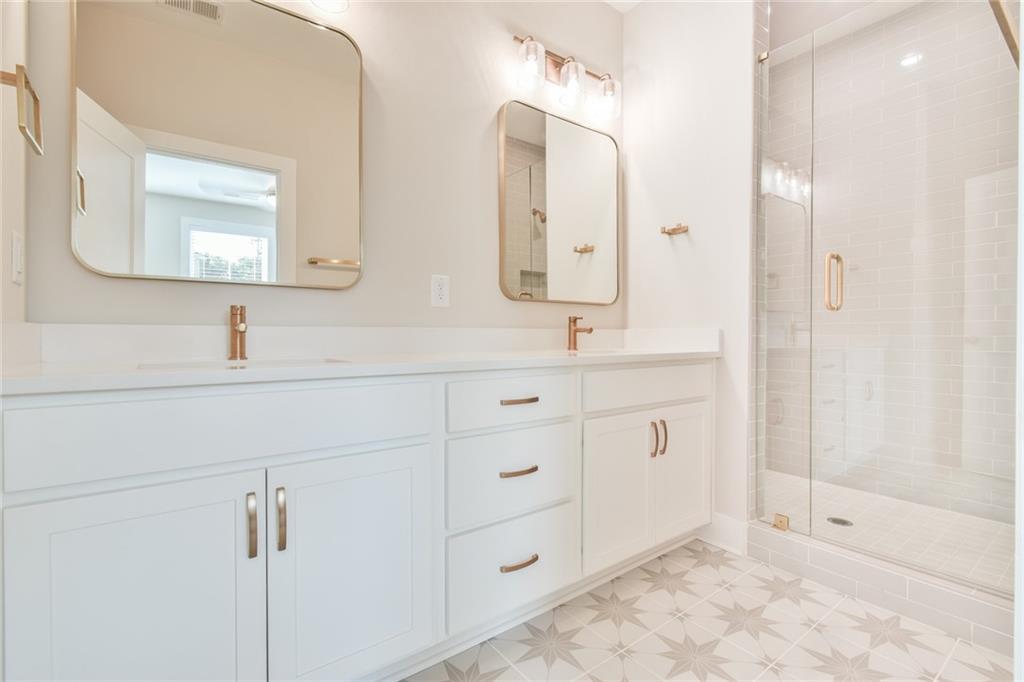 235 Firefly Circle Alpharetta, GA 30009 - Photo 27 of 30 a bathroom with a double vanity sink mirror and