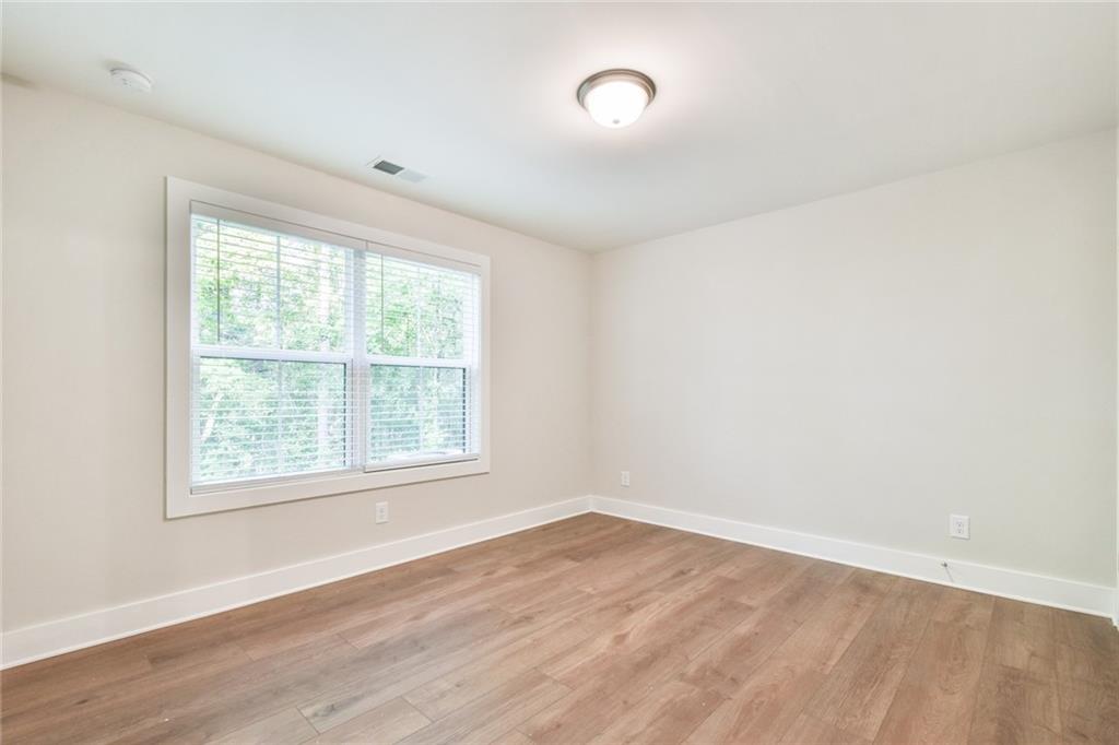 235 Firefly Circle Alpharetta, GA 30009 - Photo 29 of 30 an empty room with wooden floor and windows