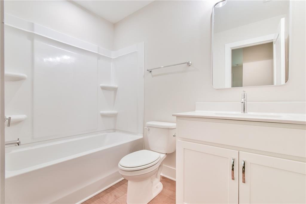 235 Firefly Circle Alpharetta, GA 30009 - Photo 30 of 30 a bathroom with a sink a toilet a mirror and shower