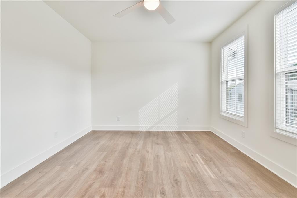 235 Firefly Circle Alpharetta, GA 30009 - Photo 4 of 30 an empty room with wooden floor and windows