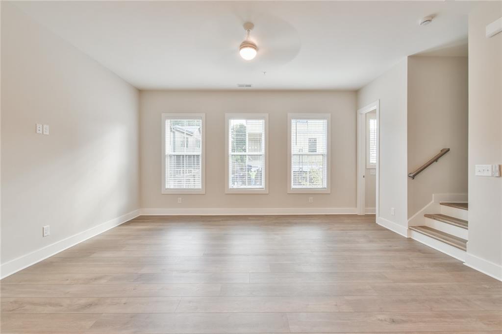 235 Firefly Circle Alpharetta, GA 30009 - Photo 5 of 30 a view of an empty room with wooden floor and a window