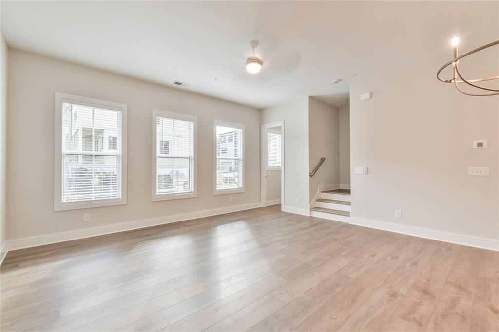 235 Firefly Circle Alpharetta, GA 30009 - Photo 7 of 30 an empty room with wooden floor and windows
