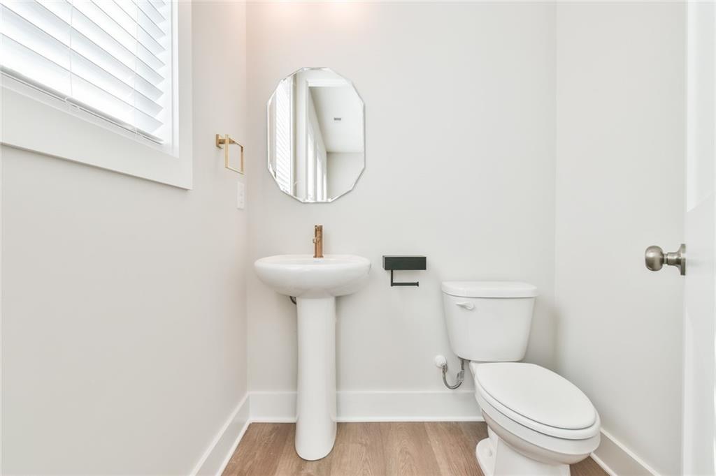 235 Firefly Circle Alpharetta, GA 30009 - Photo 10 of 30 a white toilet sitting next to a bathroom sink
