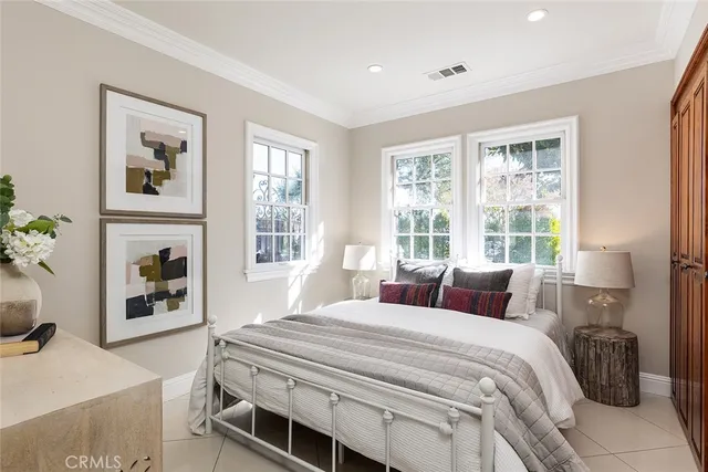 a bedroom with a balcony a bed and a fireplace