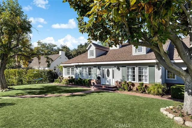 a front view of a house with a yard table and chairs