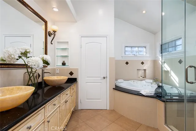 a spacious bathroom with a granite countertop sink and a mirror