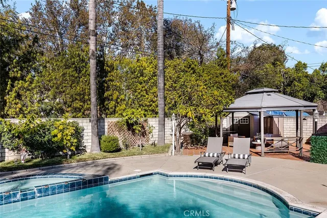 a view of a house with swimming pool and a yard