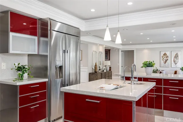 a kitchen with a sink refrigerator and cabinets