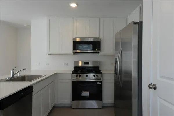 a kitchen with a sink stove and refrigerator
