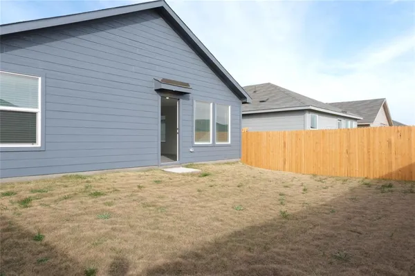 a view of an house with backyard and garage