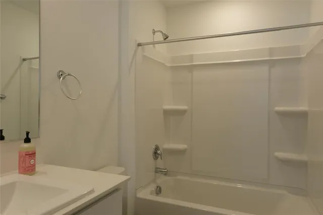 a bathroom with a shower and a bath tub