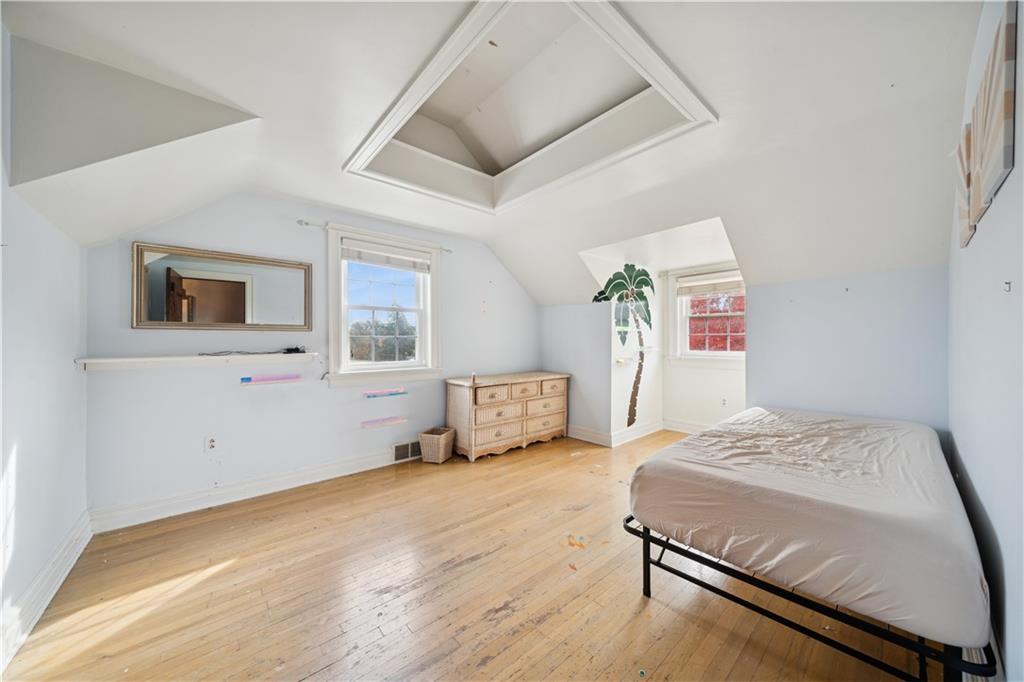 1512 Abers Creek Road Pittsburgh, PA 15239 - Photo 20 of 39 a bedroom with a bed and wooden floor