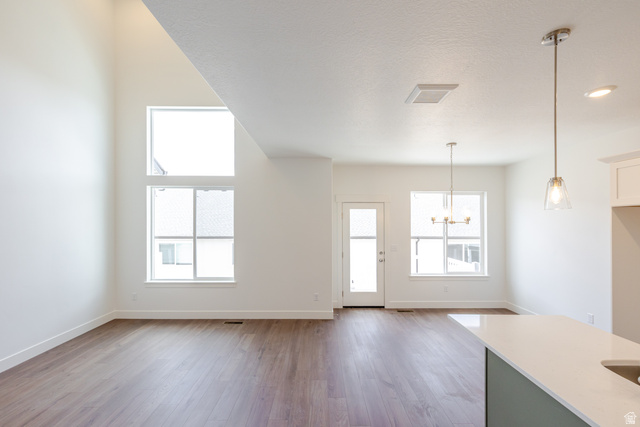 4816 Heartwood Road, Unit 423 Mapleton, UT 84664 - Photo 12 of 21 Unfurnished dining area with a chandelier and light wood-type flooring