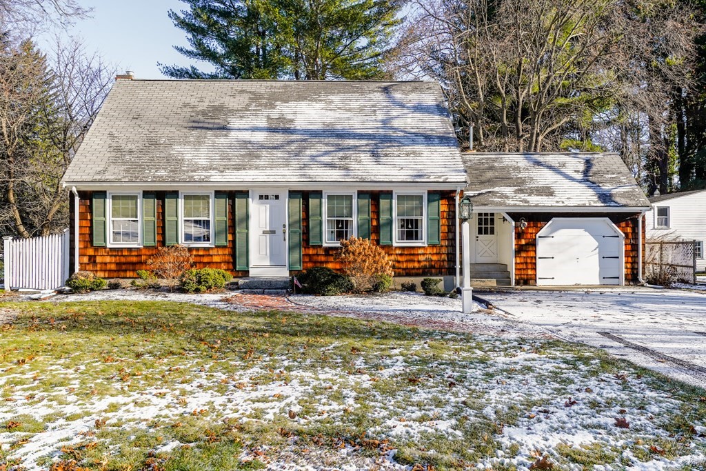 a view of a house with large area and a car parked in front of it