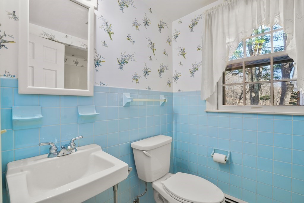 61 Walnut Street Shrewsbury, MA 01545 - Photo 17 of 38 a bathroom with a toilet sink and mirror