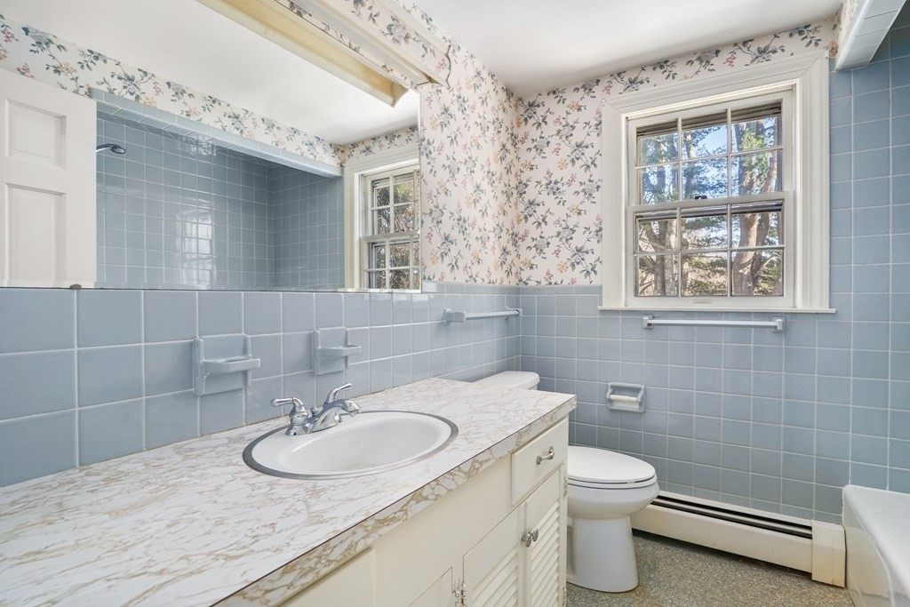 61 Walnut Street Shrewsbury, MA 01545 - Photo 24 of 38 a bathroom with a toilet sink and mirror