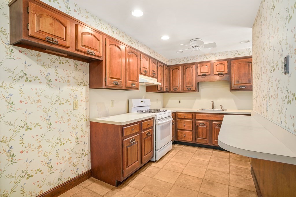 61 Walnut Street Shrewsbury, MA 01545 - Photo 3 of 38 a kitchen with stainless steel appliances granite countertop a stove a sink and a microwave