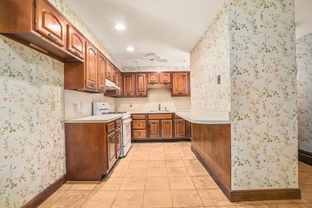 61 Walnut Street Shrewsbury, MA 01545 - Photo 5 of 38 a large kitchen with stainless steel appliances granite countertop a stove a sink and a microwave
